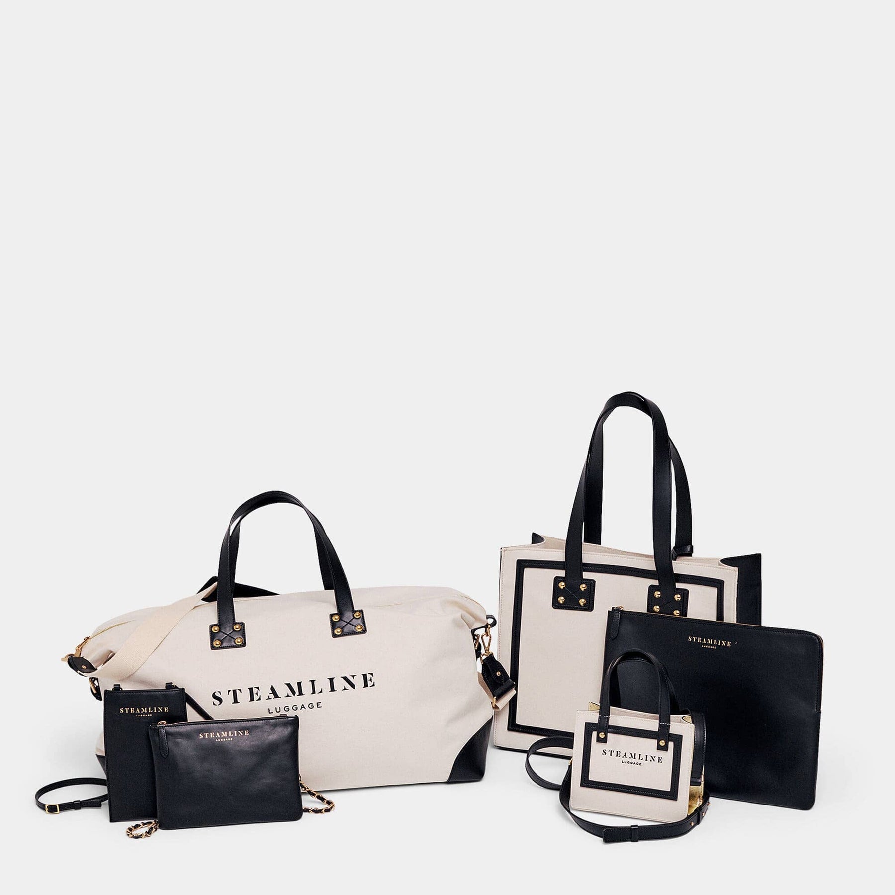 Designer travel set of The Navigator handbag in sustainable canvas and black leather with gold trims