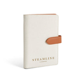 Angled product view of the Navigator leather passport holder in white with nut trim and gold logo