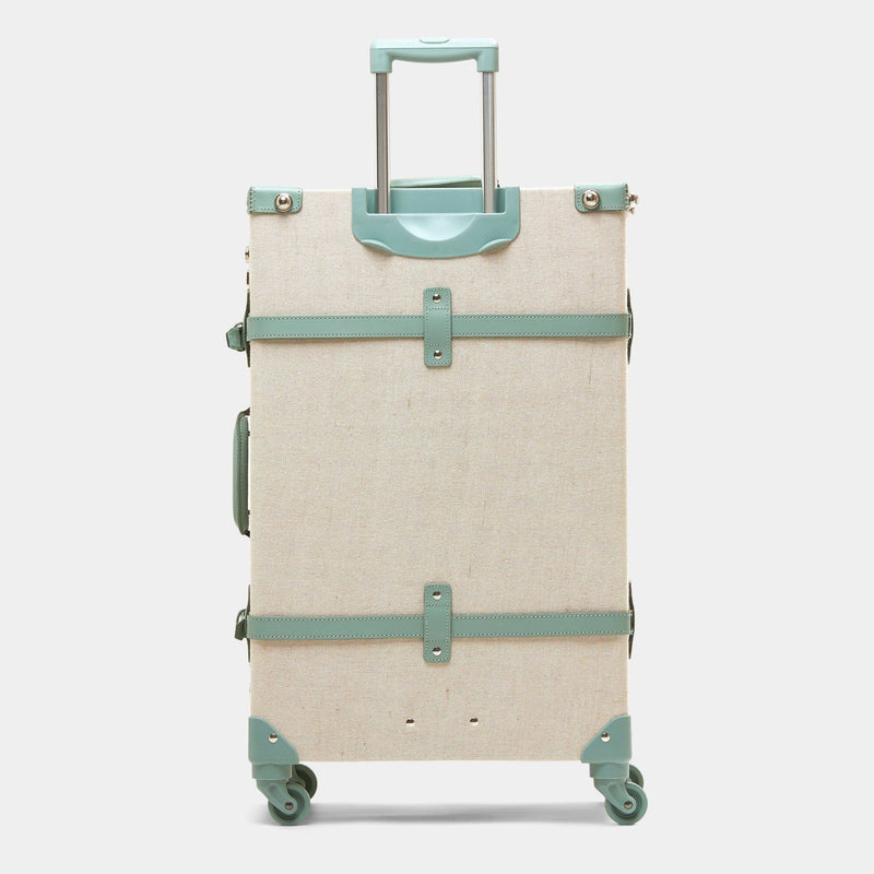 Back product view of the check-in spinner Editor linen suitcase with sea green trims and raised handle