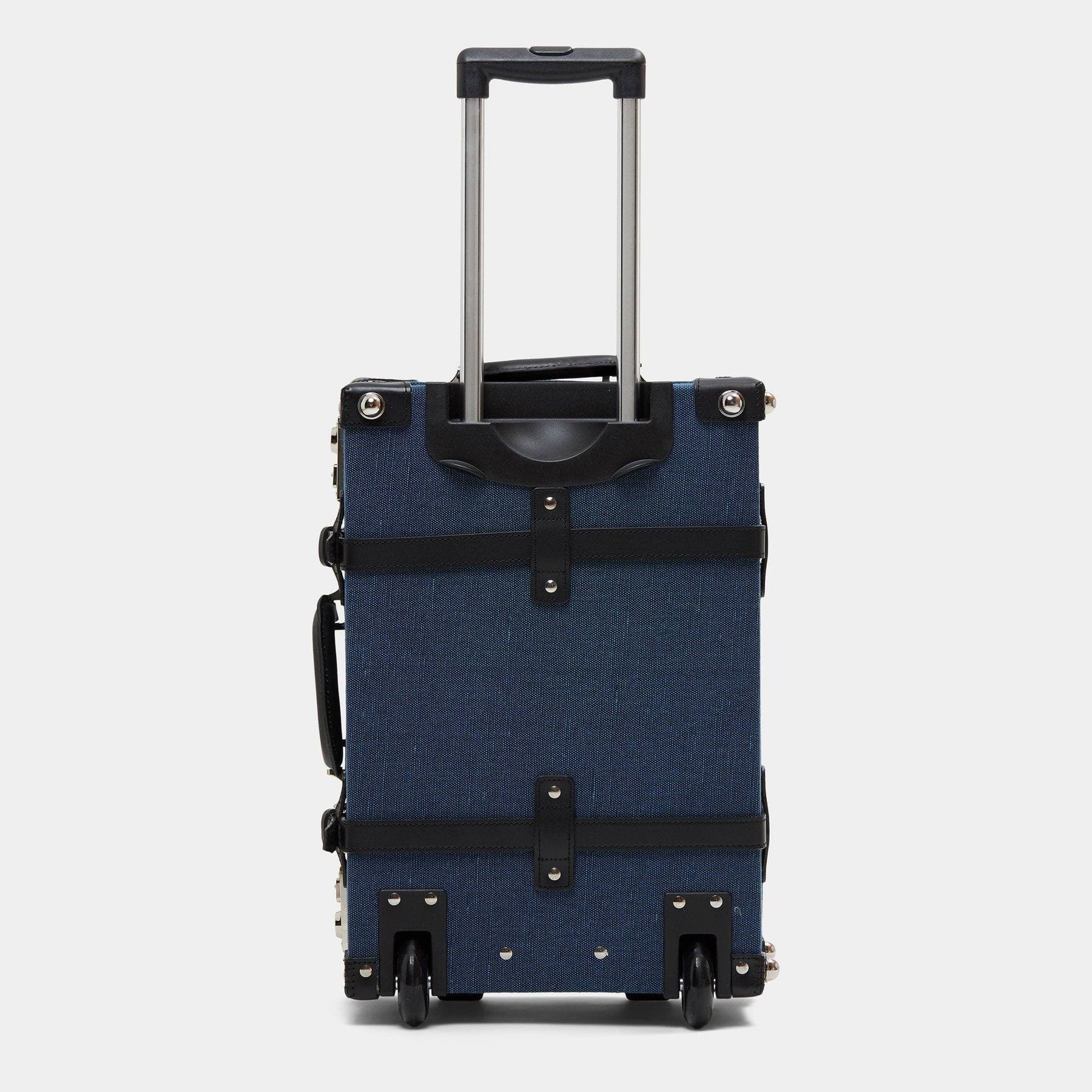 Back product view of the carry-on Editor linen suitcase with navy body, black trims and raised handle