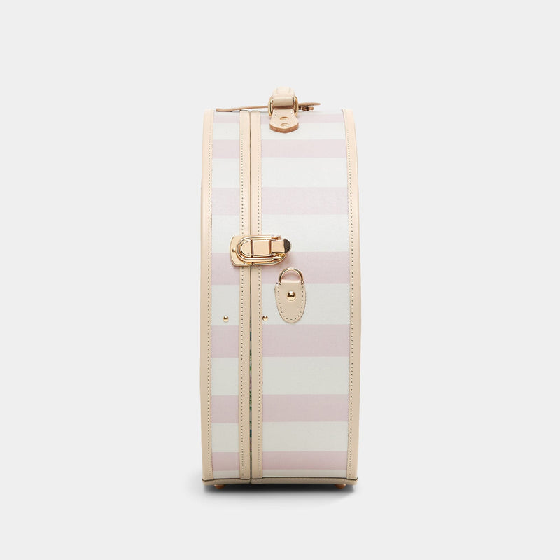 Side product view of the deluxe hatbox Illustrator fibreboard suitcase in pink-stripe with shoulder attachment strap