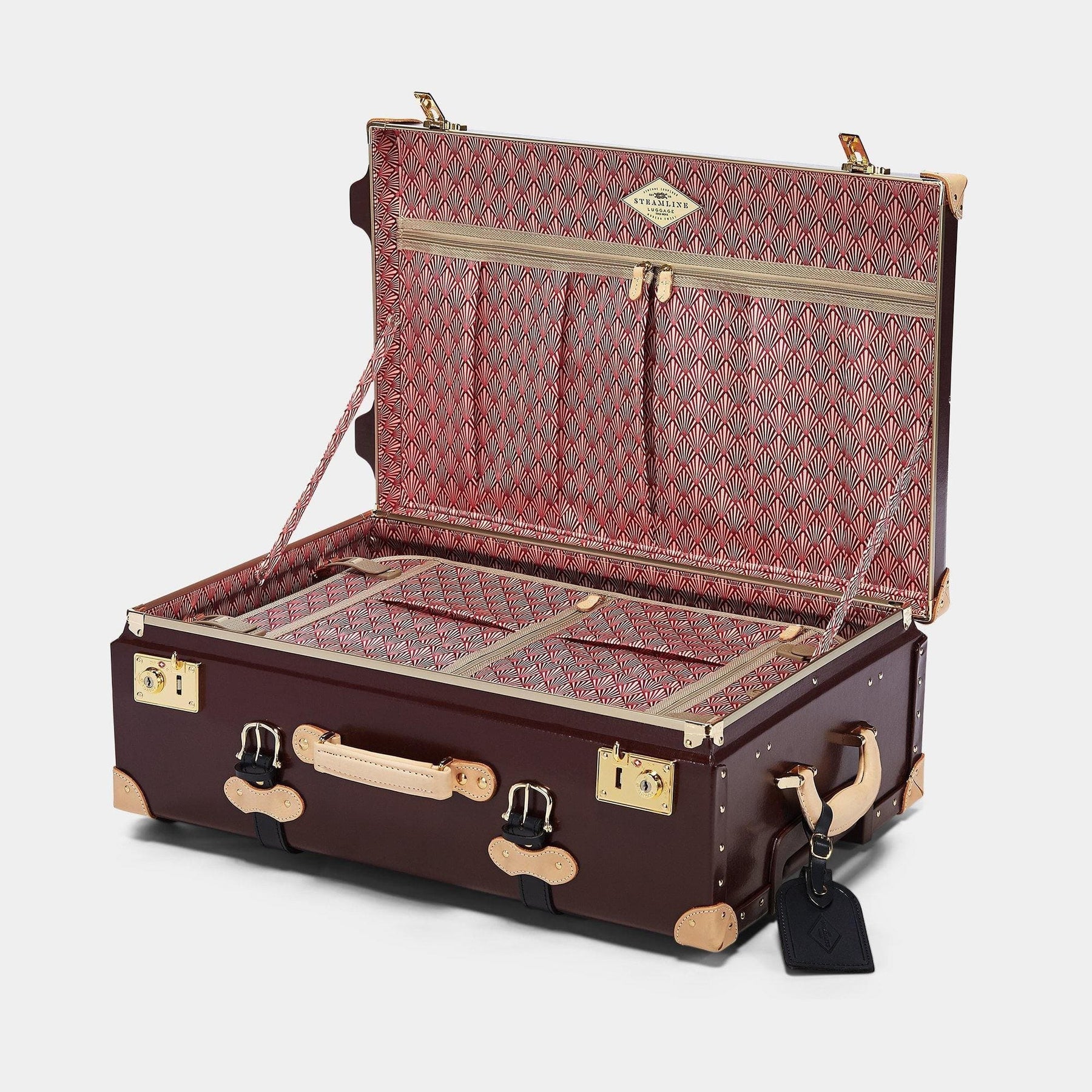 Open product view of the stowaway Architect leather suitcase in burgundy with art deco printed lining and black leather luggage tag