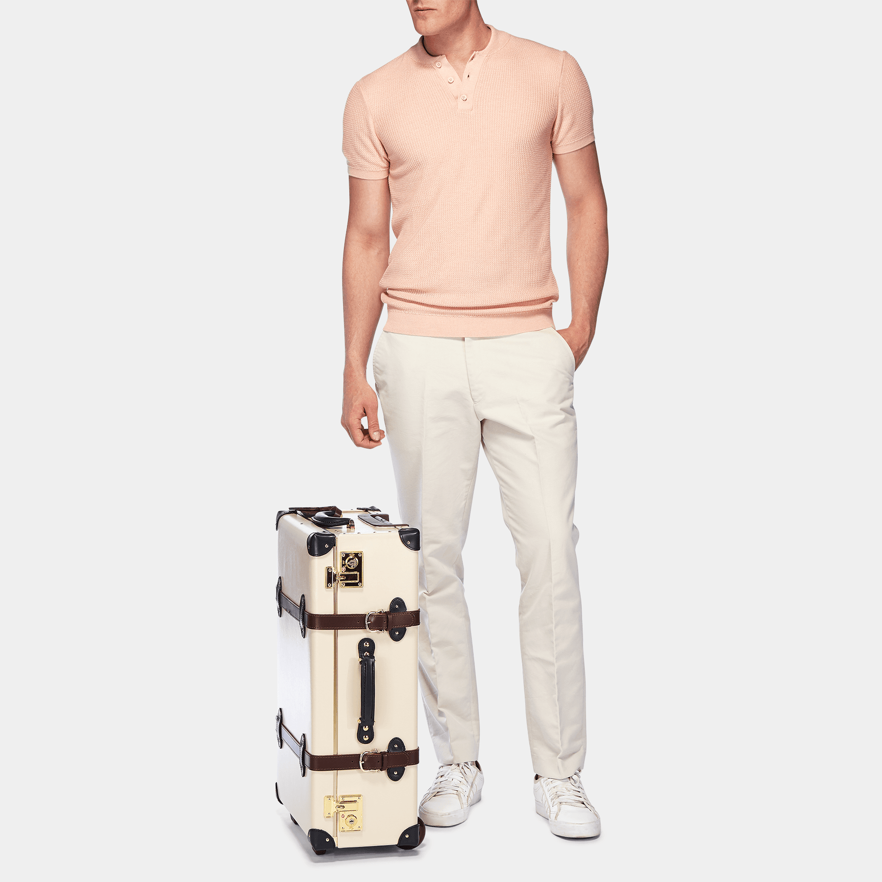 Male model with the stowaway Architect leather suitcase in cream