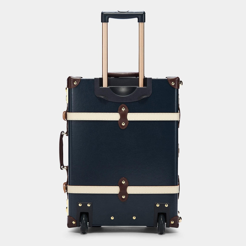 Back product view of the carry-on Architect leather suitcase in navy with raised handle