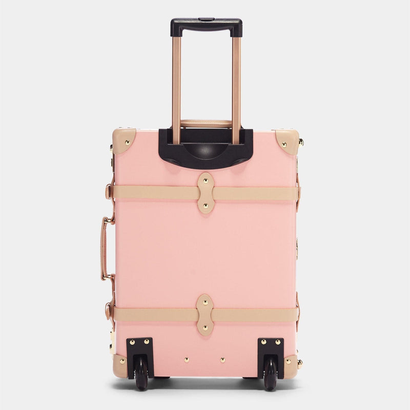 Back product view of the carry-on Correspondent fibreboard suitcase in pink with raised handle