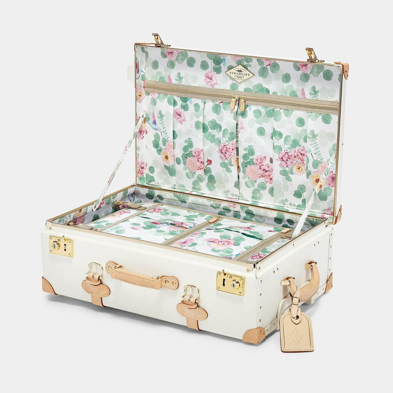 Open product view of the stowaway Sweetheart fibreboard suitcase in cream with botanical printed lining