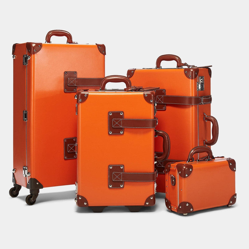 Steamline vintage luggage set of The Anthropologist leather suitcase in orange.