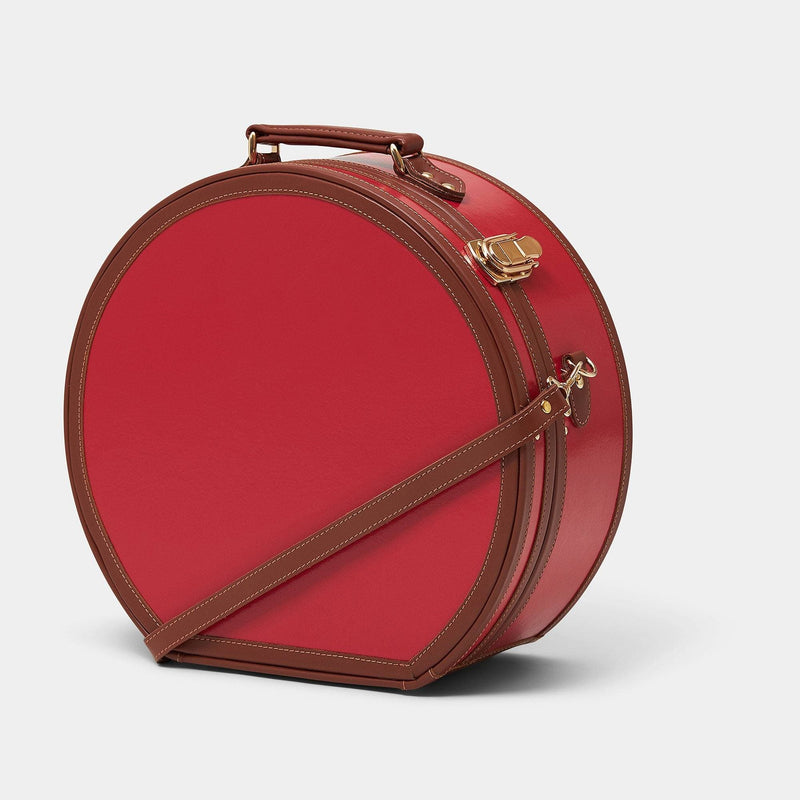 Angled product view of the large hatbox Diplomat leather suitcase in red with shoulder attachment strap