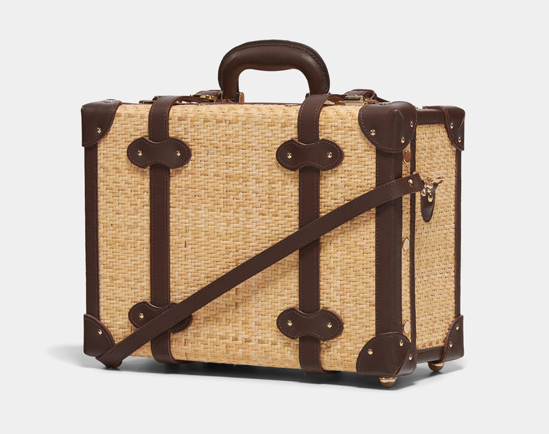 Angled product view of the overnighter Explorer rattan suitcase in  natural wicker body and brown trims