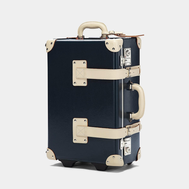 Angled product view of the carry-on Anthropologist leather suitcase in navy
